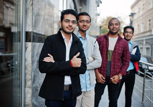 Group of four indian teen male students. Classmates spend time together.